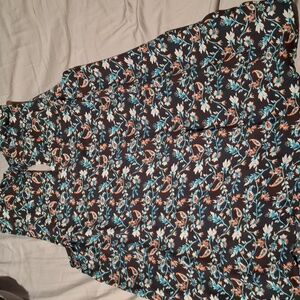 Beautiful sleeveless, small slits on each side as well as back, button closure.